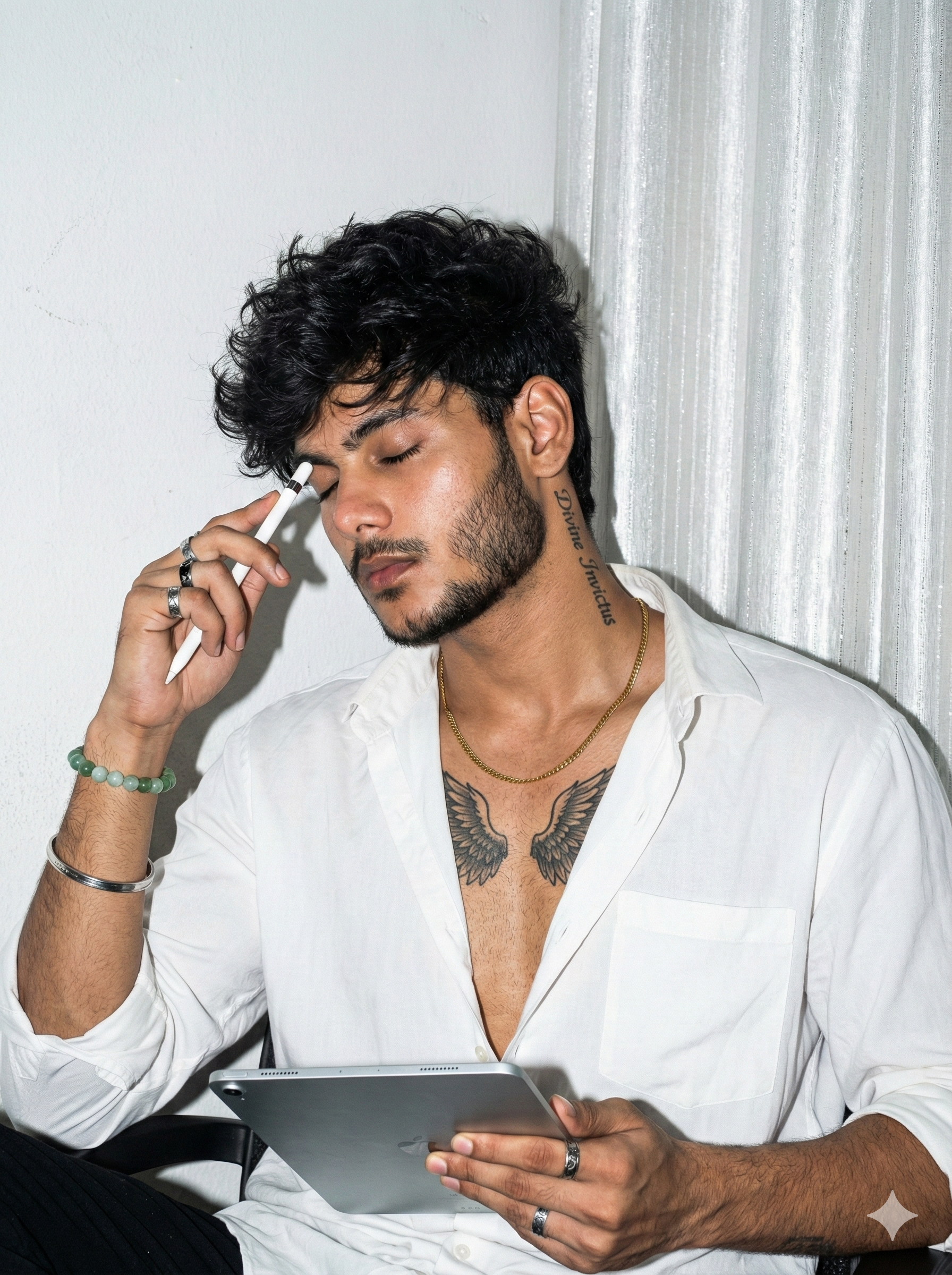 ULTRA-REALISTIC 8K PORTRAIT of a stylish young man [ keep it real face from uploaded image ]
"A hyper-realistic portrait of a handsome young man with messy dark wavy hair and a, sitting in a relaxed pose. He look at front and is pressing a white stylus pen against his temple in a gesture of deep thought, while holding a grey digital tablet in his other hand. He is wearing a loose white button-down shirt, unbuttoned deeply to reveal his chest, showing a tattoo of wings on his chest and a vertical script tattoo on the side of his neck reading 'Divine Invictus'. He is accessorized with a gold chain, a jade beaded bracelet, a silver cuff, and rings. The background features a texture of white  and a shimmering  white curtain. The lighting is cool and sharp, highlighting the texture of his skin and hair, fashion photography style."
quality, 8k.The lighting style is direct camera flash photography, giving it a raw, urban, and slight retro film aesthetic stylish pose